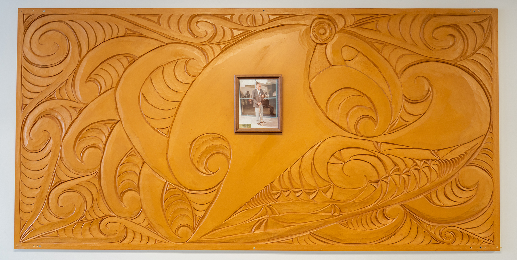 NorthAble Matapuna Hauora Carving with an inset photo of a kaumātua